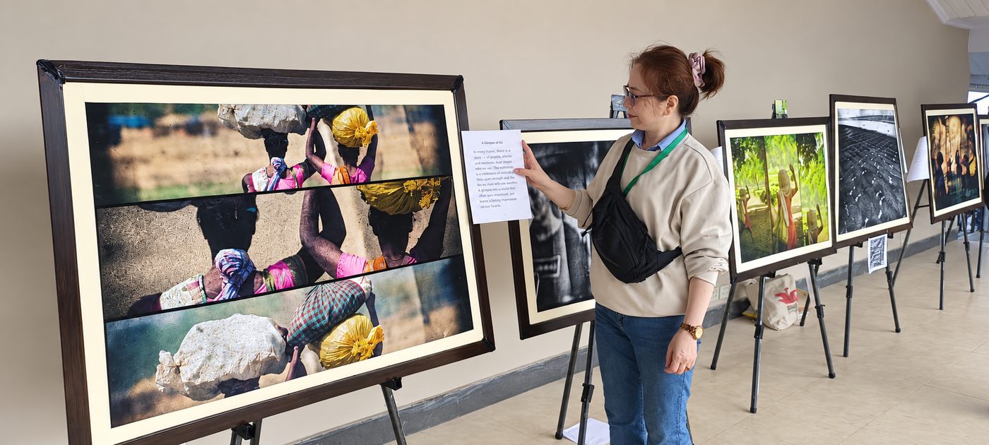 Visitors viewing framed photographs at the exhibition