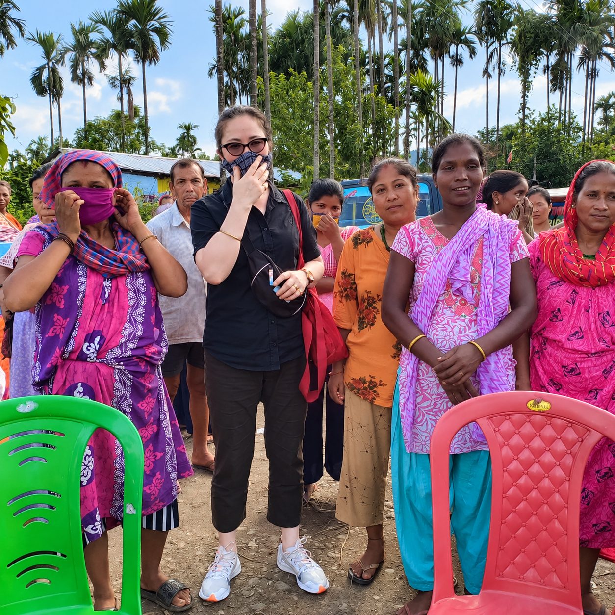 GWWF worker standing with women from a village community